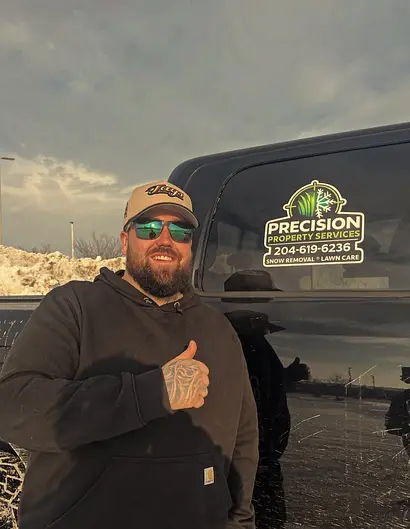 Dylan Tayfel, owner of Precision Property Services, beside his branded truck