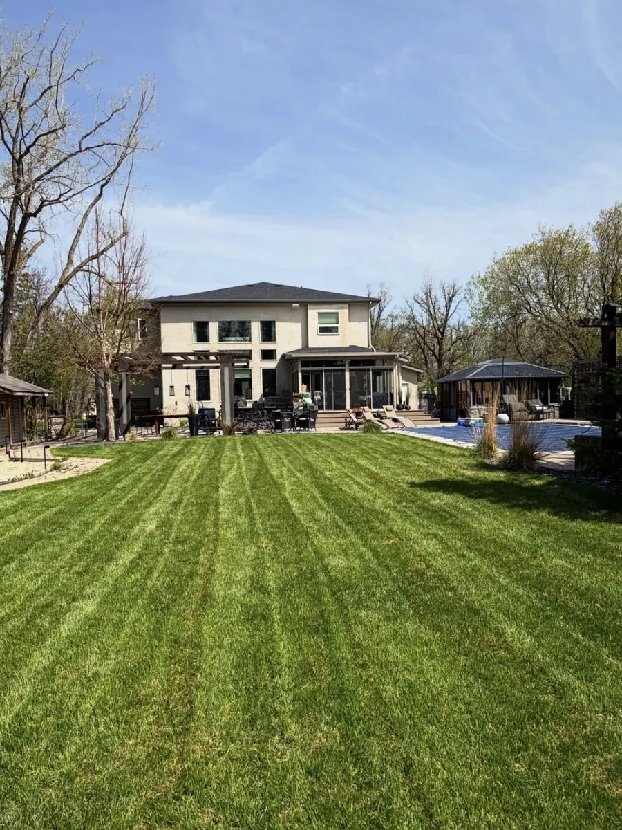 Freshly mowed striped lawn behind a large home in Winnipeg Freshly mowed striped lawn behind a large home in Winnipeg
