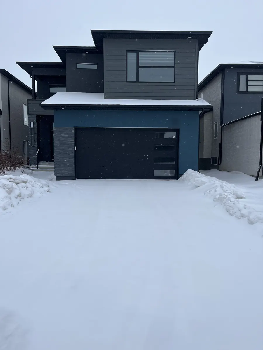 Two-car driveway covered in snow before clearing in Winnipeg Two-car driveway covered in snow before clearing in Winnipeg