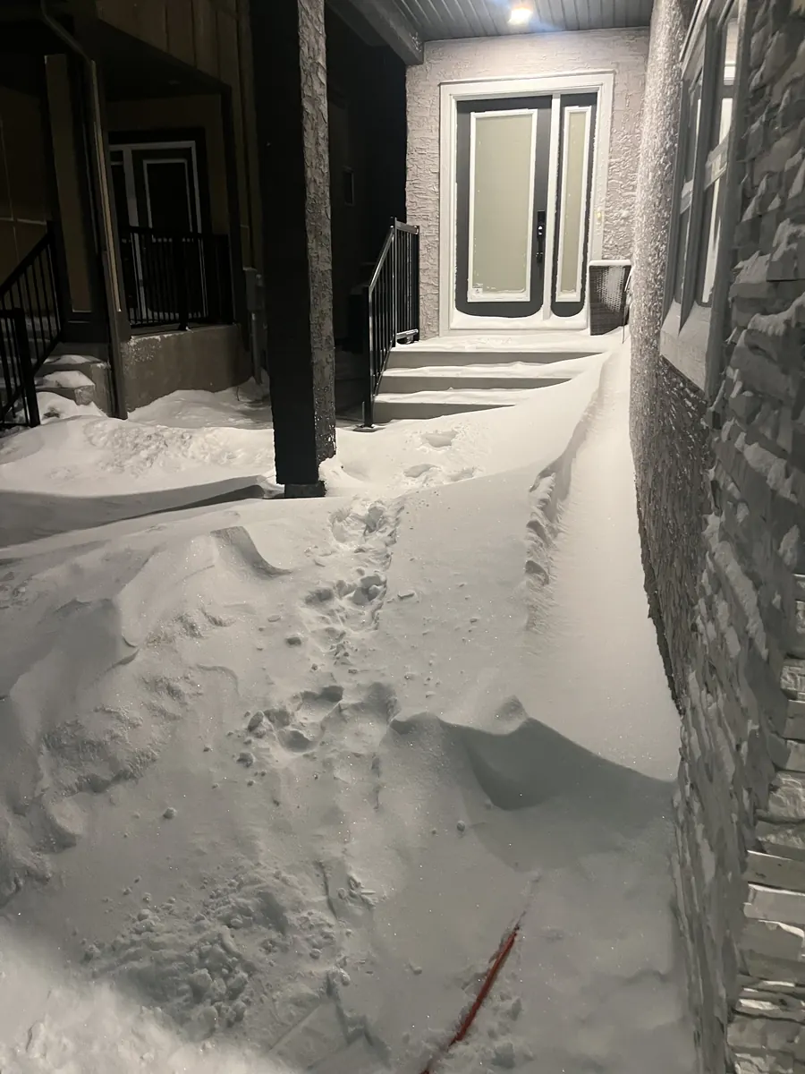 Front walkway buried in a deep snowdrift at night Front walkway buried in a deep snowdrift at night